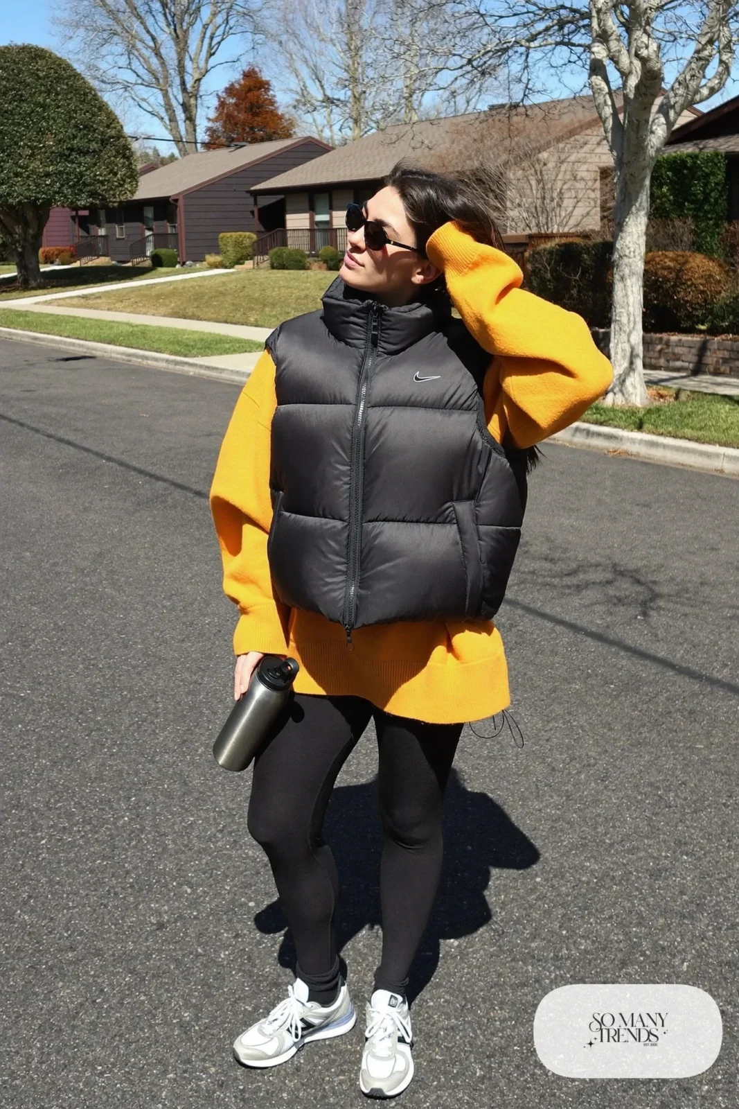 oversized mustard sweater black leggings gray sneakers black puffer vest water bottle january outfit 6