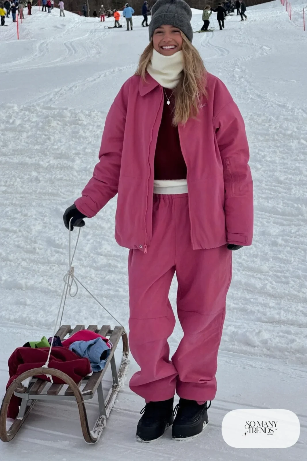 pink insulated ski jacket and matching snow pants merino base layer waterproof mittens snow boots helmet-free beanie outfit 7