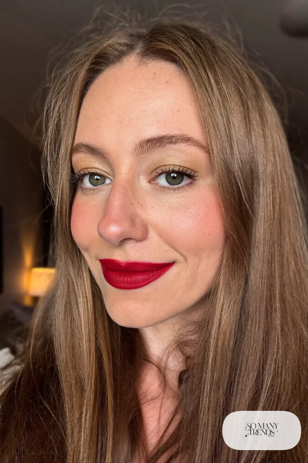 woman with cherry red satin lipstick, defined brows and natural skin, makeup look 1