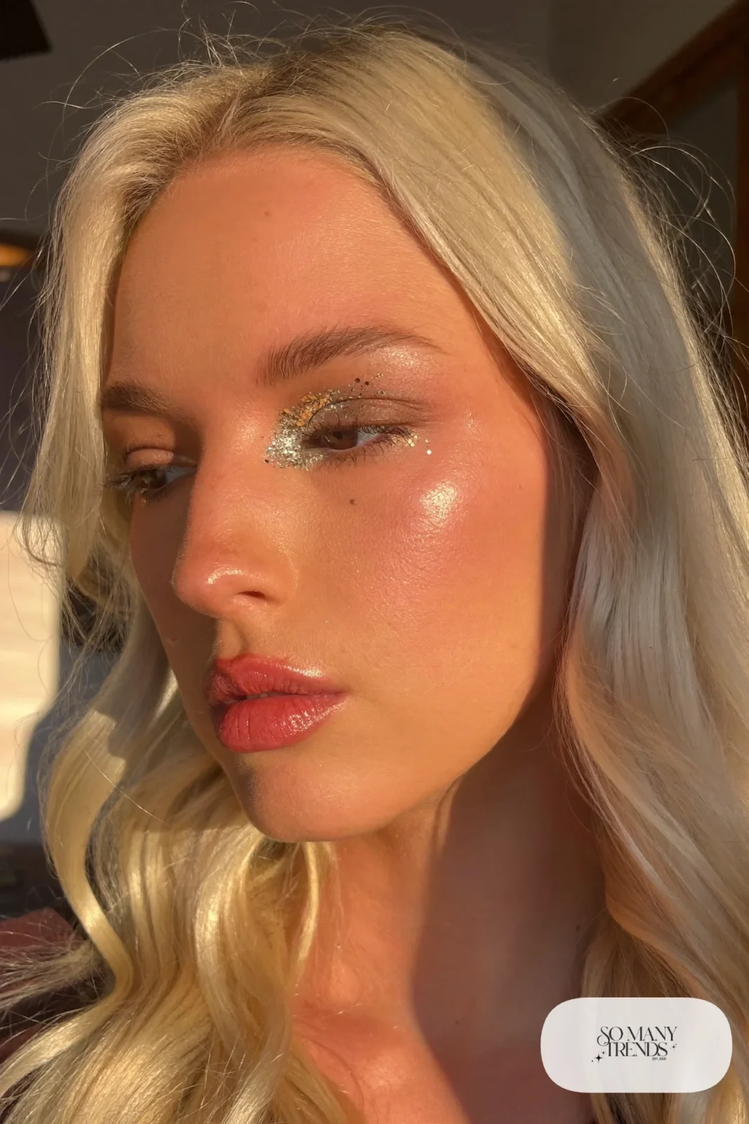 blonde woman with silver and gold glitter on eyelids and sheer peach lip, makeup look 5