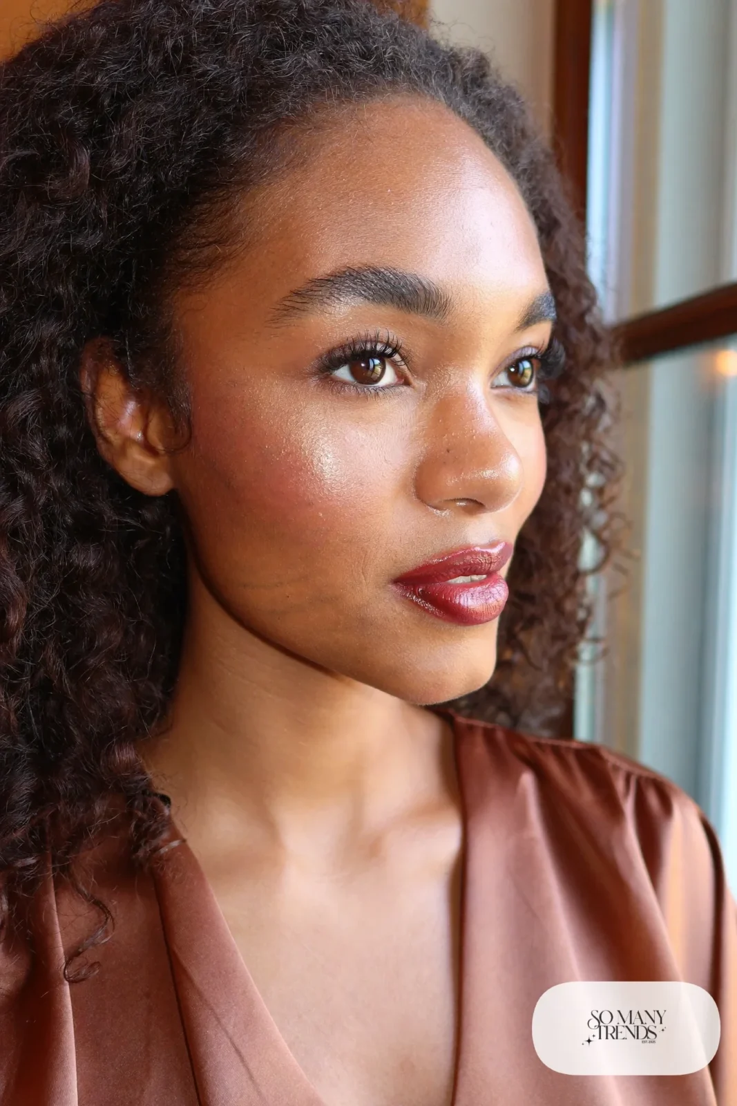 woman with dewy natural skin, fluffy brows and glossy tinted lips, makeup look 8