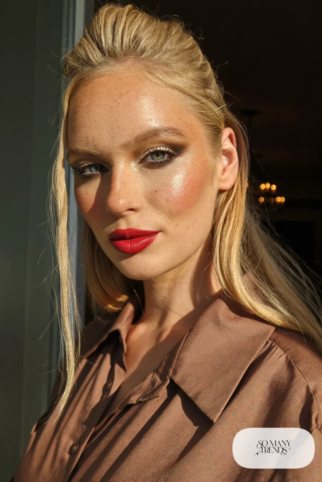 woman with dramatic charcoal smoky eye and bold red lip, glowing skin, makeup look 10