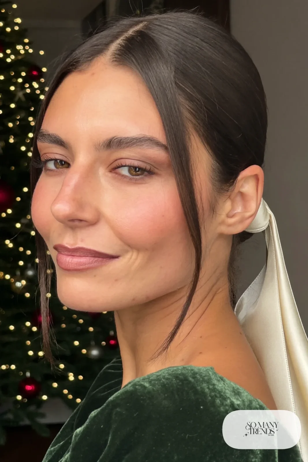 dark brown low bun with cream satin ribbon and face-framing strands, simple makeup, hairstyle 2