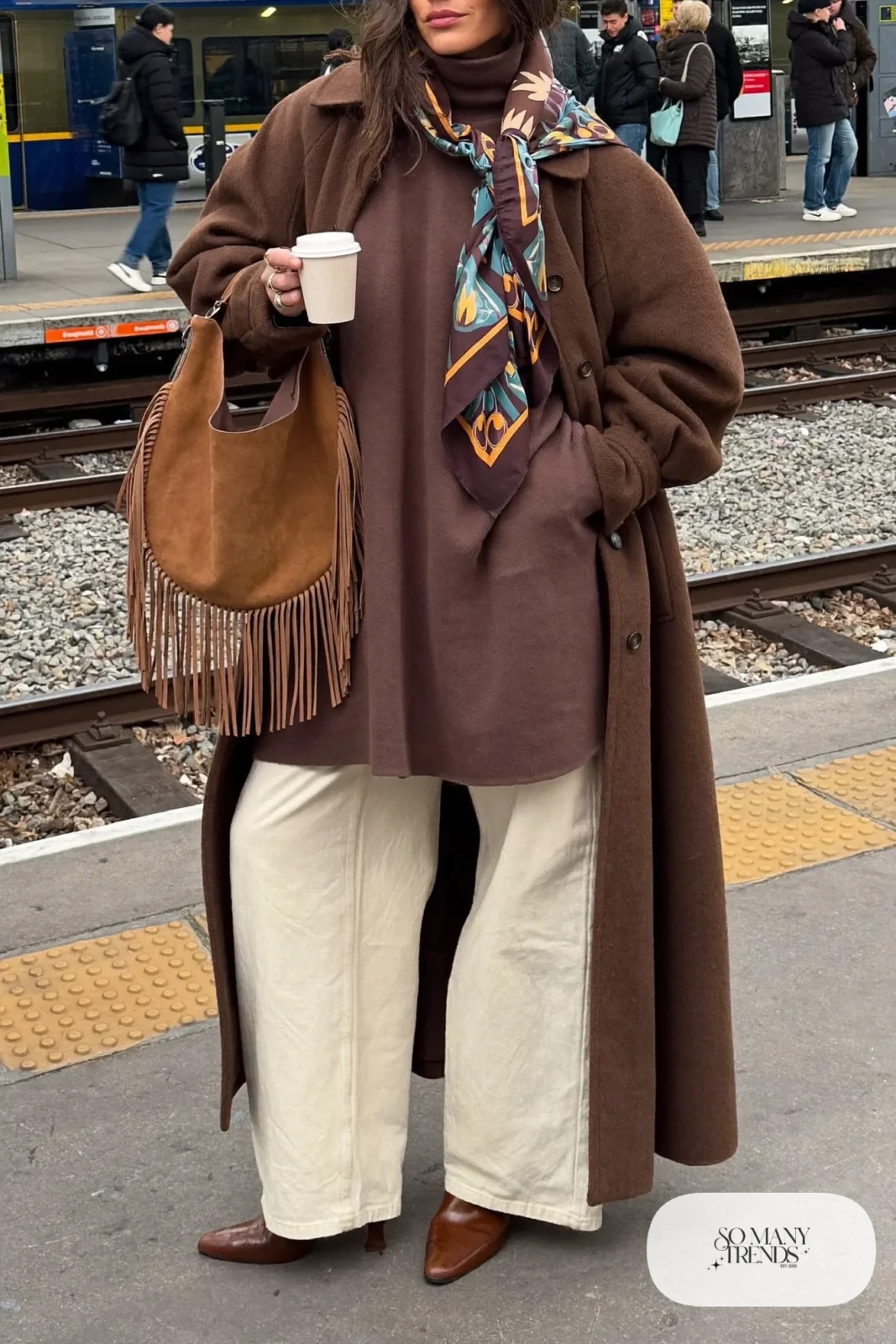 long camel wool coat chocolate turtleneck wide-leg cream pants fringe suede bag leather boots outfit 4