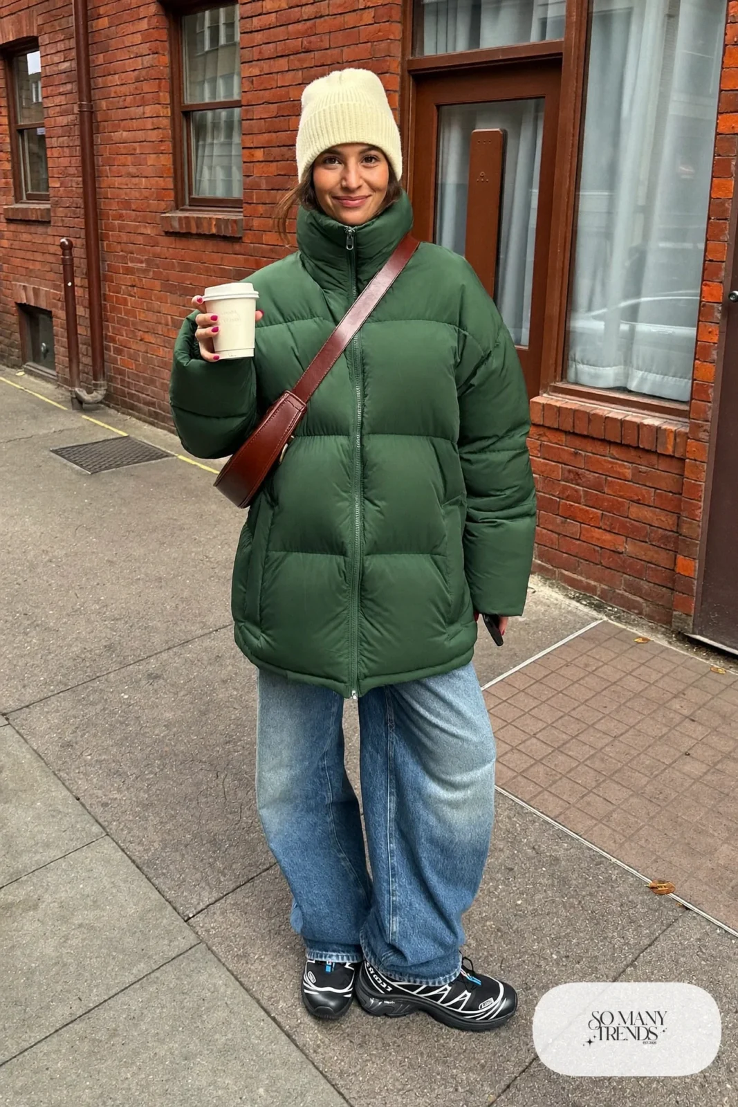 forest green oversized puffer jacket, wide-leg blue jeans, black Salomon XT-6 sneakers, cream beanie outfit 1