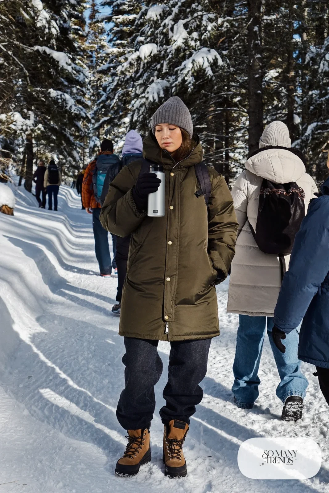 olive parka with hood, gray beanie, fleece-lined jeans, waterproof hiking boots, backpack outfit 23