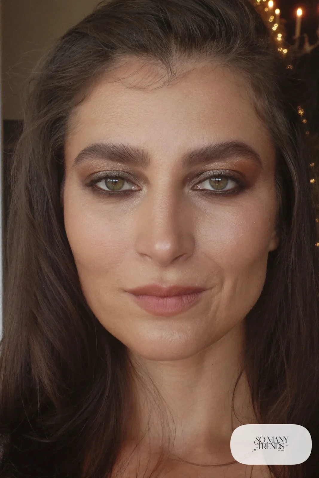 woman with brown smoky eye makeup, smudged liner and nude lip, makeup look 9