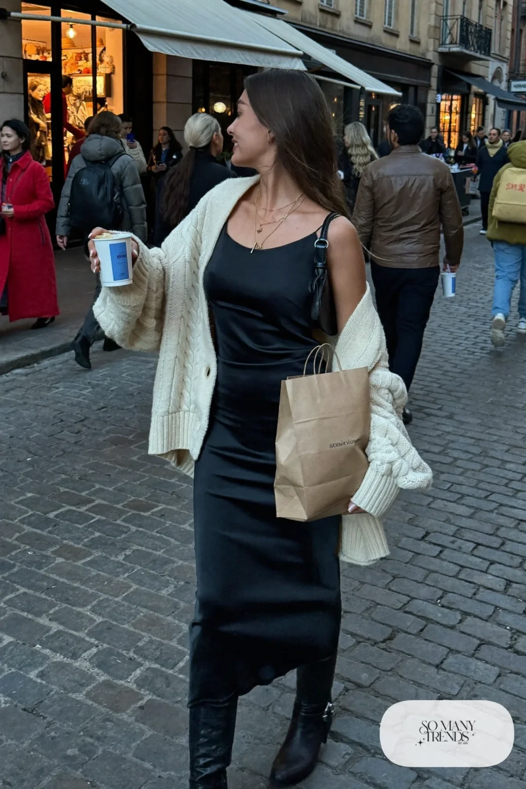 black satin midi slip dress oversized cream cable knit sweater black knee high boots mini shoulder bag outfit 9