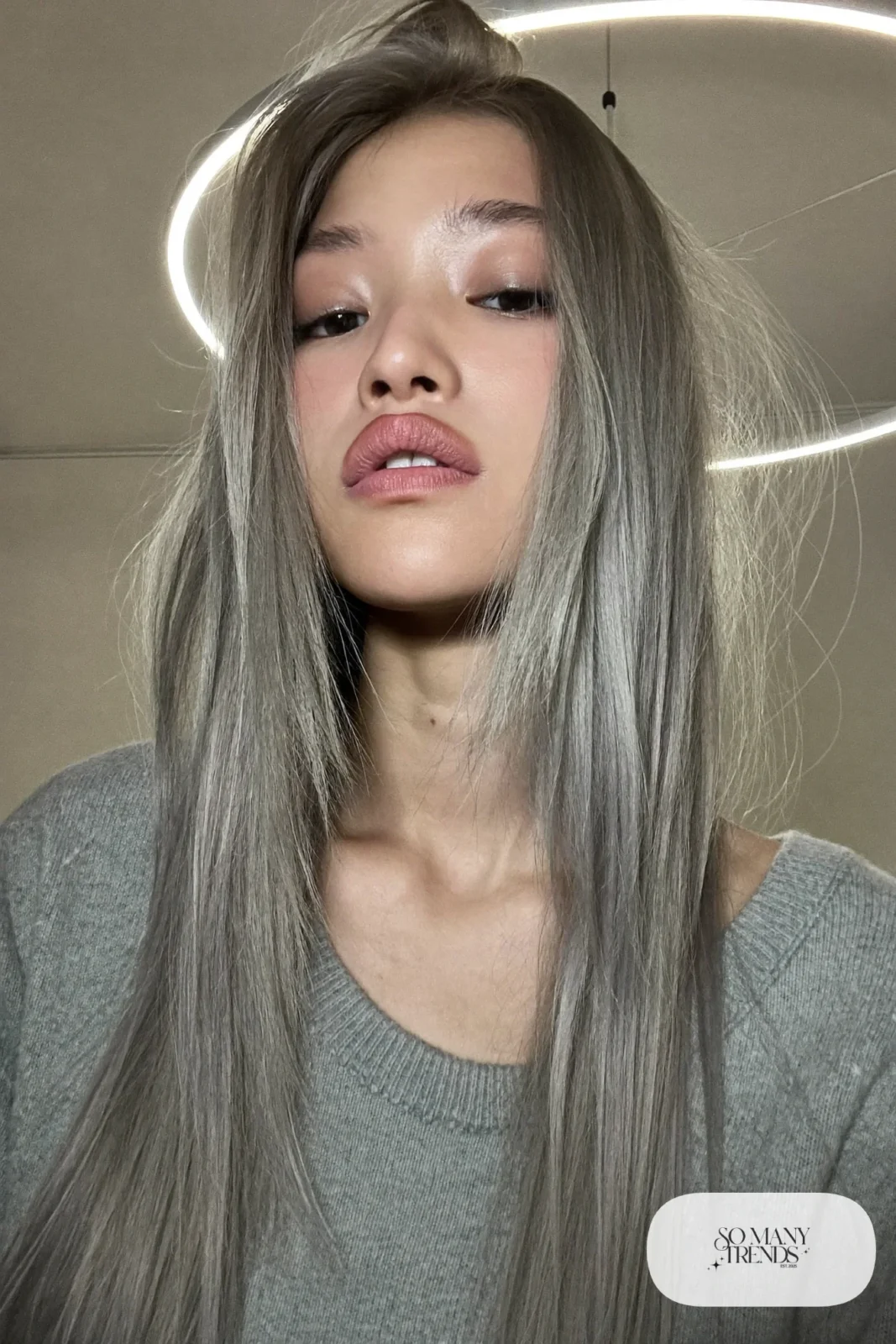 woman with long straight layered ash gray-blonde hair worn down, natural makeup, haircut 3
