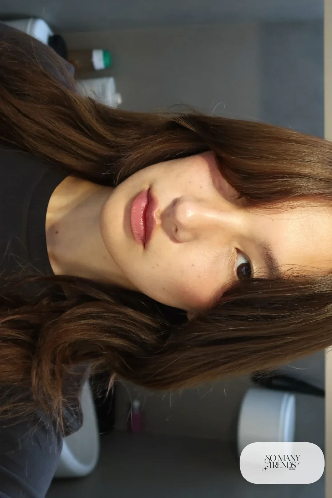 woman with espresso brown curtain bangs and long layers worn down, natural makeup, haircut 4