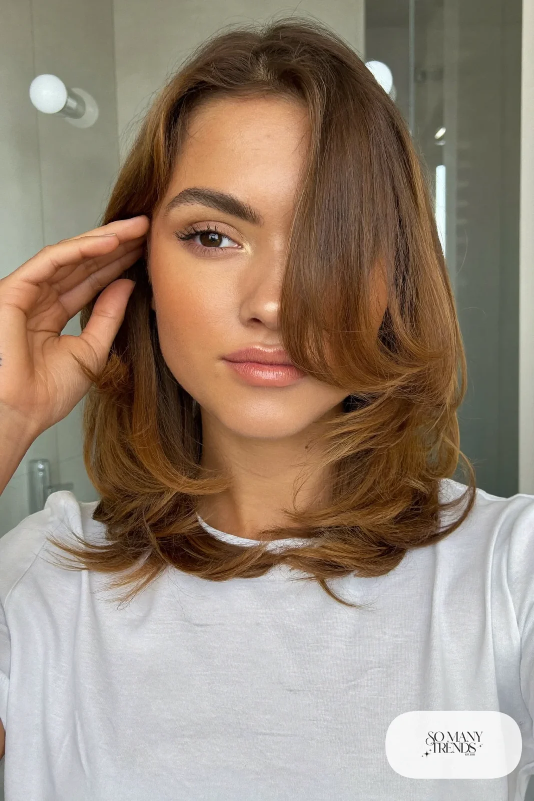 woman with caramel highlighted layered lob worn down, natural makeup, haircut 6
