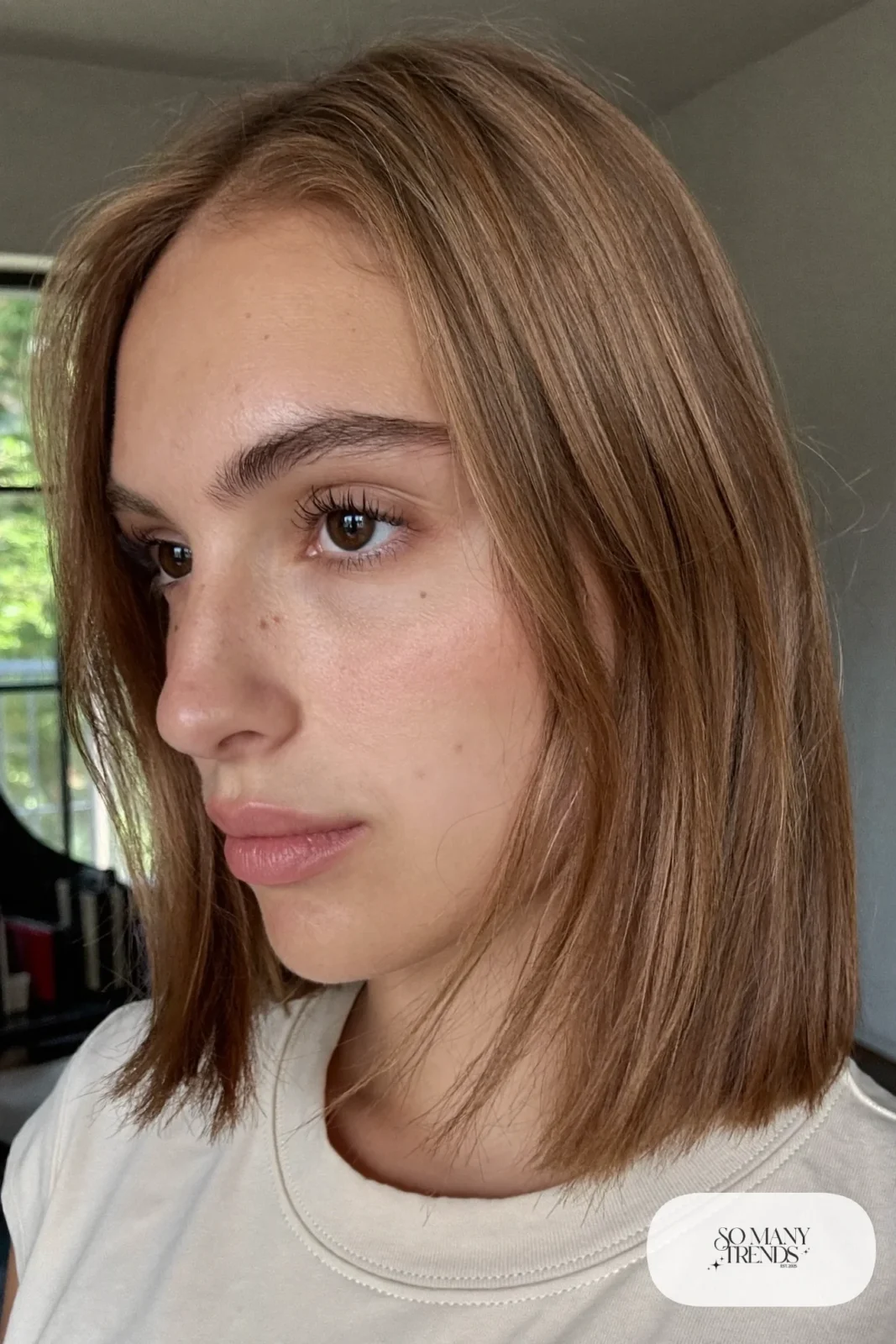 woman with chestnut layered bob with blunt edge worn down, natural makeup, haircut 8