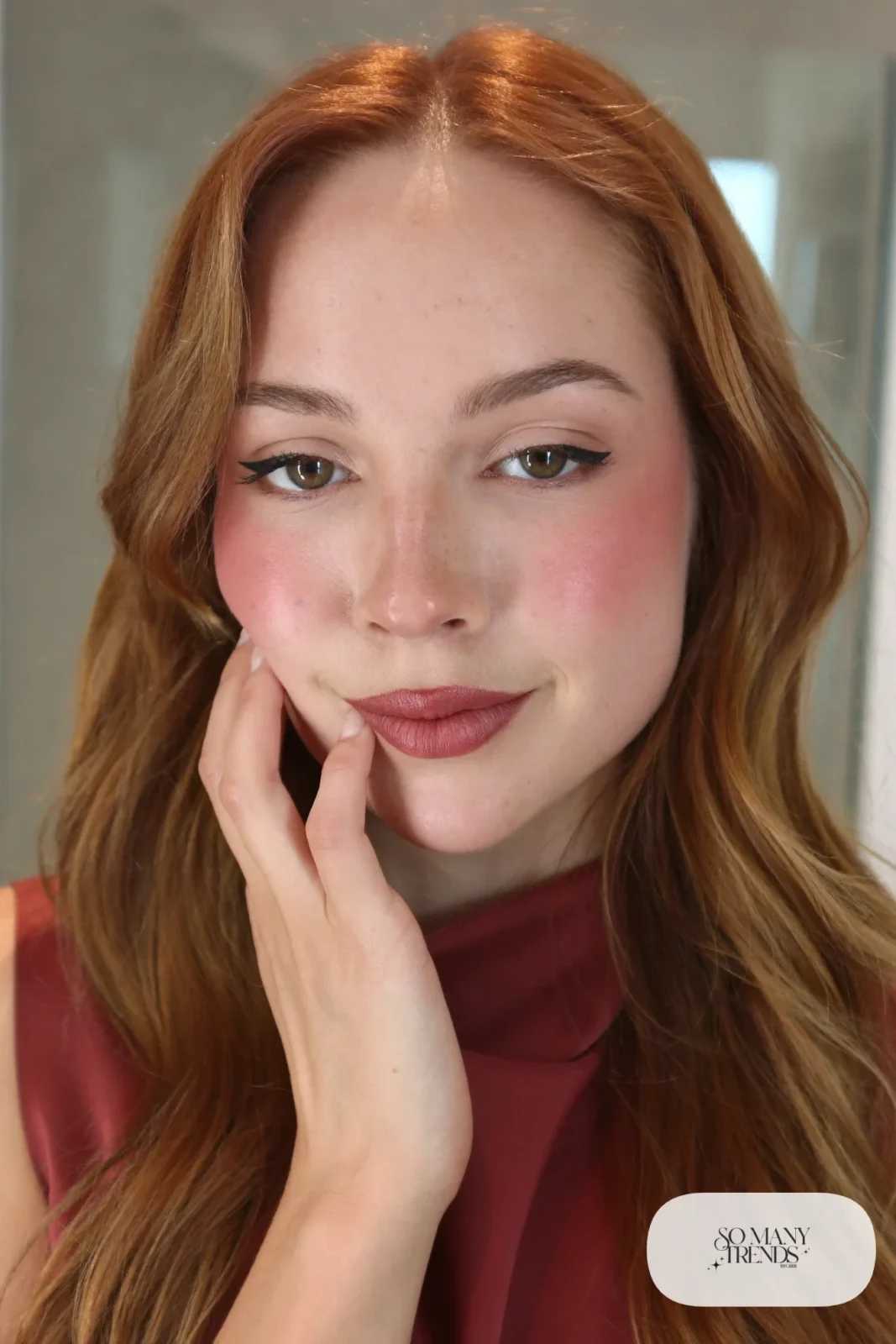 woman with a thin clean winged eyeliner and berry lips, winter makeup look 6