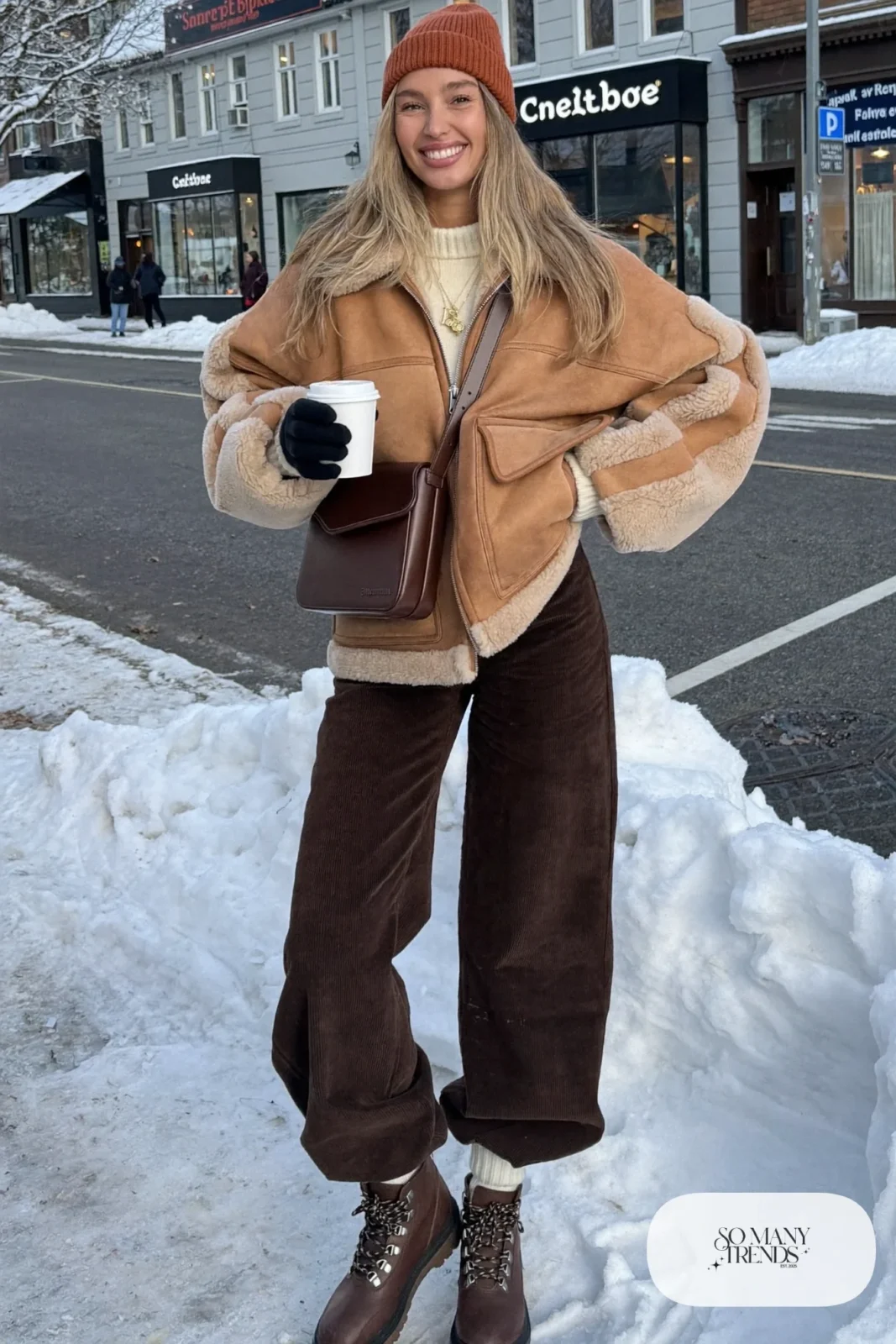 oversized tan faux shearling jacket cream chunky turtleneck chocolate brown wide-leg corduroy pants brown lace-up boots rust beanie outfit 31