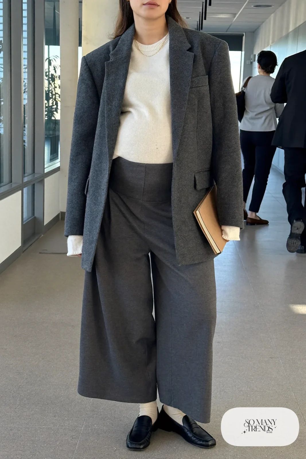 pregnant woman in charcoal oversized blazer, cream knit sweater, wide-leg maternity pants and black loafers, outfit 2