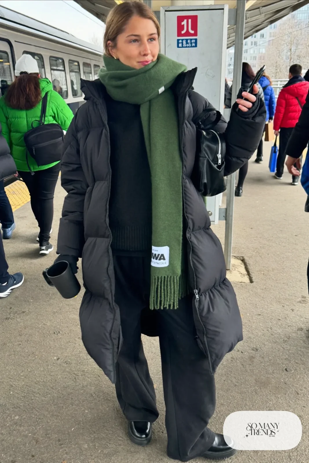 black boxy puffer jacket green wool wrap scarf black wide-leg pants chunky boots backpack outfit 26