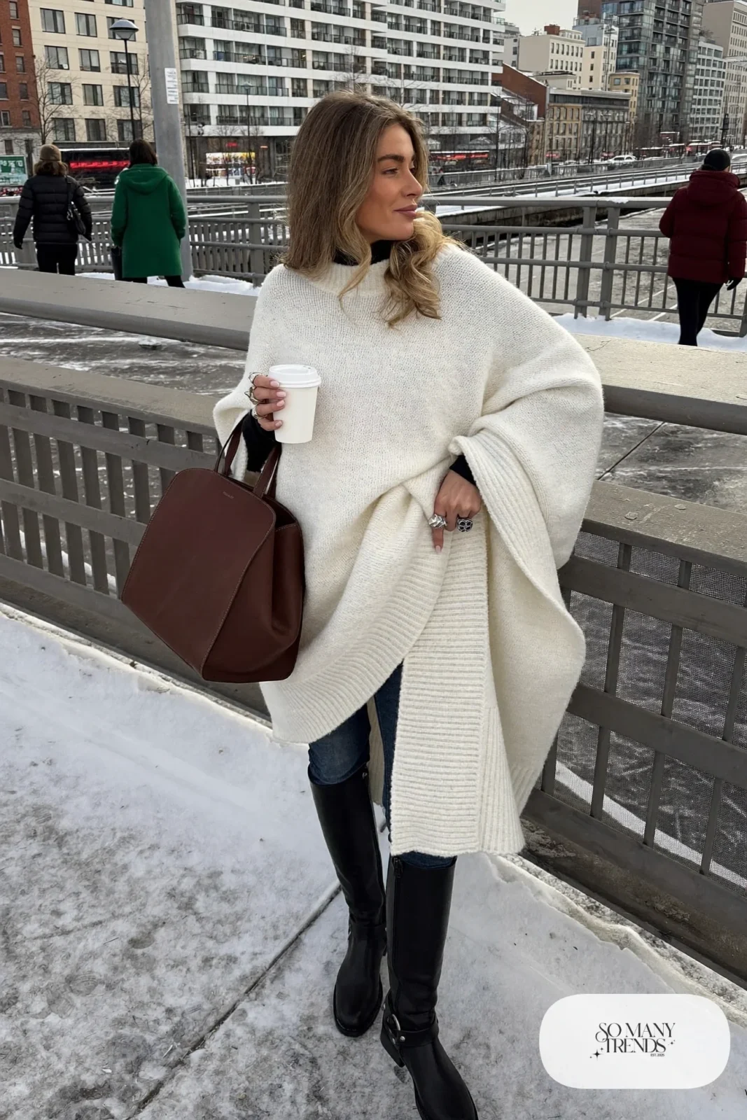 white chunky knit poncho dark slim jeans black knee boots black turtleneck leather tote outfit 19