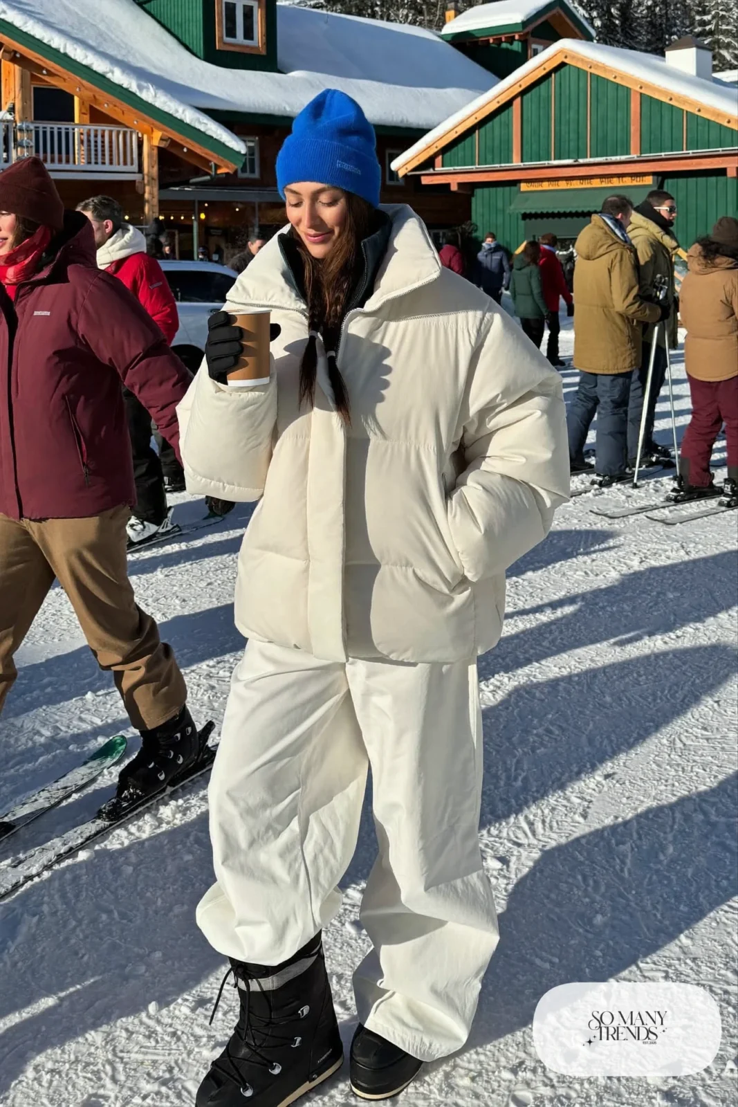 white insulated ski jacket white baggy snow pants cobalt beanie gloves winter boots outfit 22