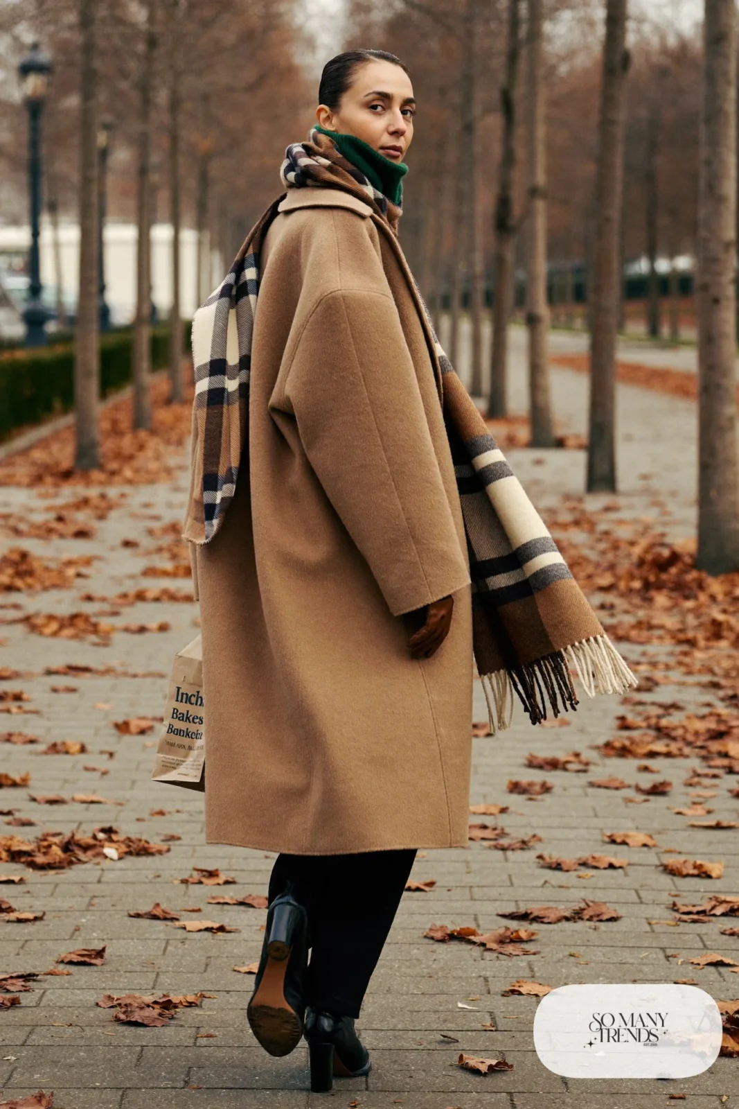 long camel wool coat forest green turtleneck straight black pants ankle boots outfit 2