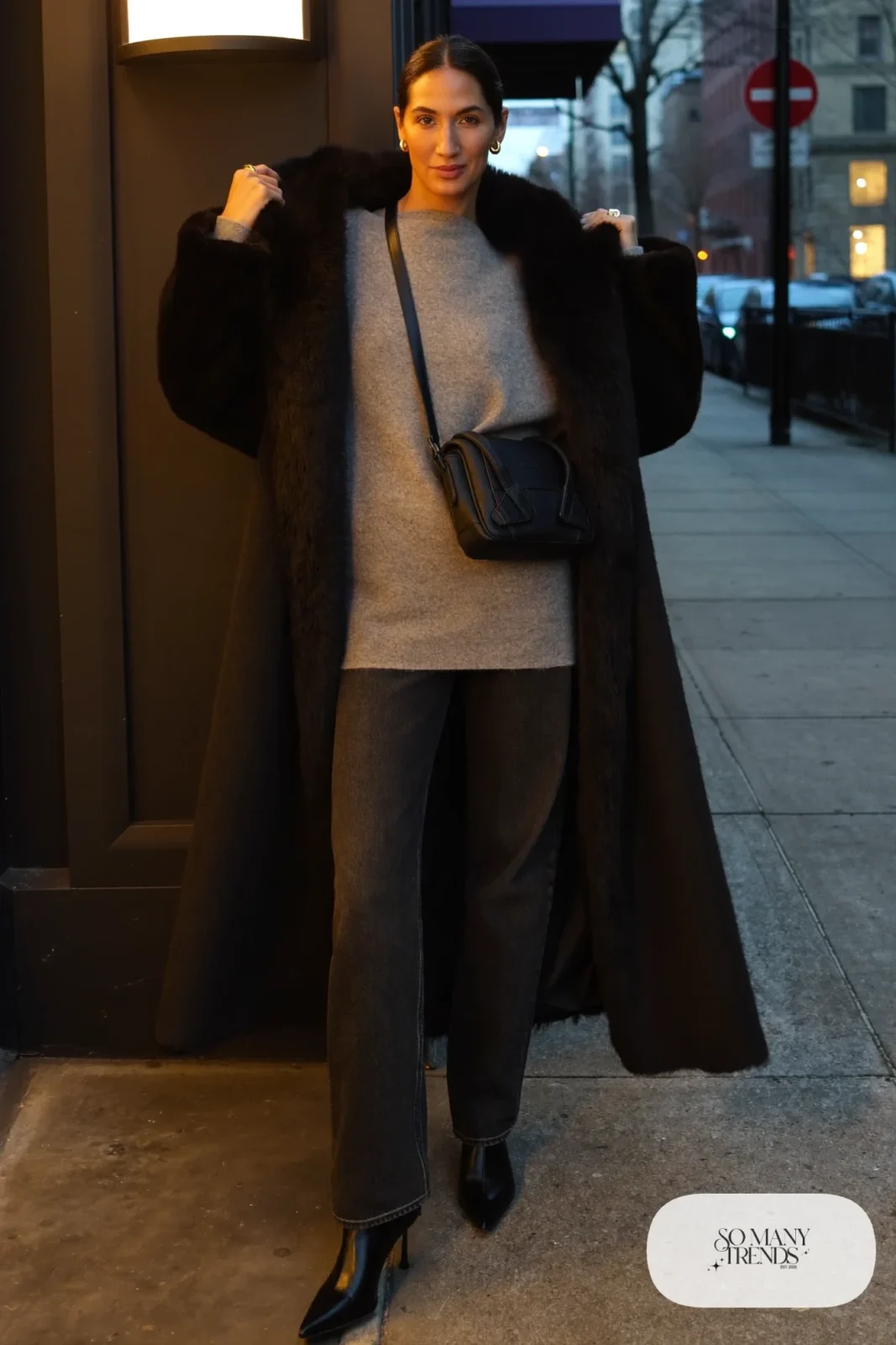 black coat faux fur collar gray knit dark straight jeans black boots outfit 10