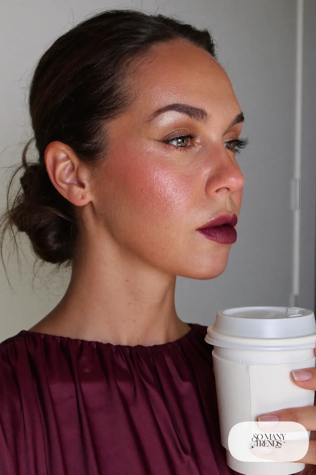 woman with dewy skin, liquid highlighter and berry lip balm, winter makeup look 8