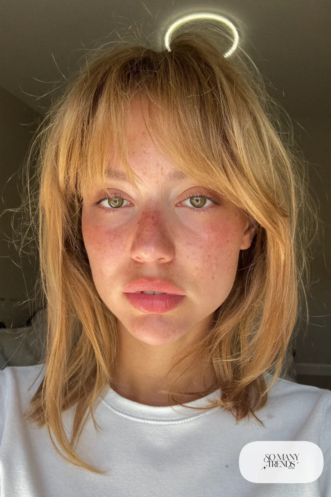 woman with honey blonde shaggy mid-length layers and wispy bangs worn down, natural makeup, haircut 9