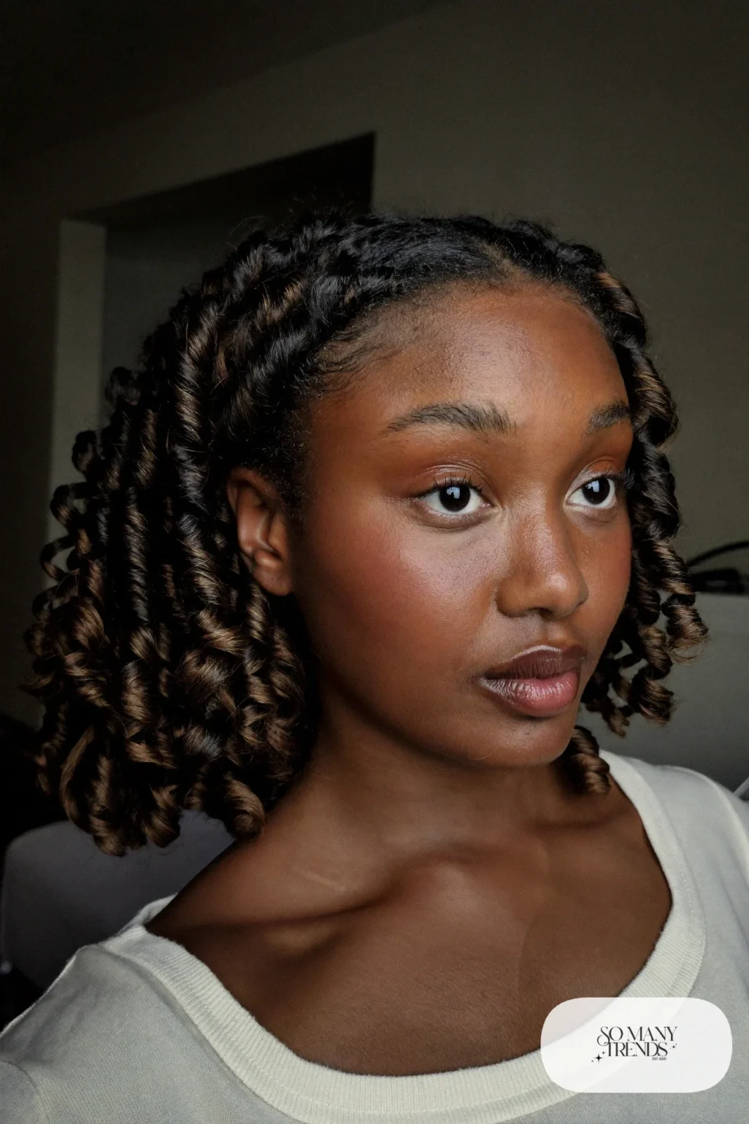 woman with dark brown curly layered hair worn down, natural makeup, haircut 10