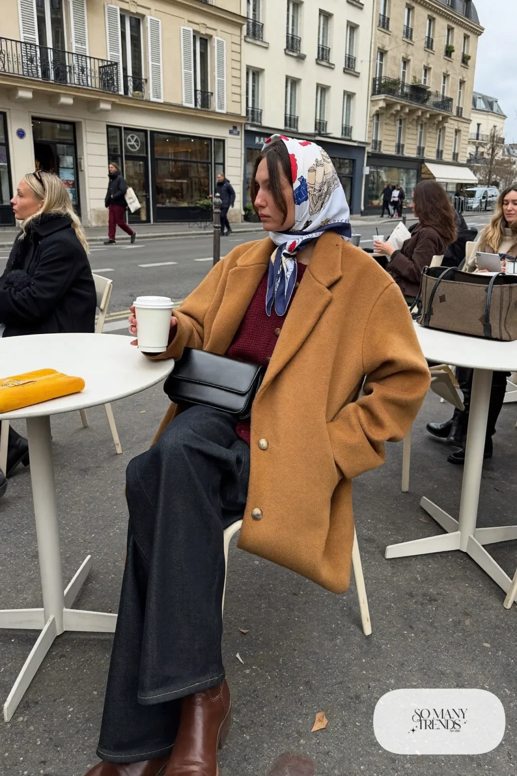 camel wool coat burgundy knit sweater dark wide-leg jeans brown leather ankle boots silk scarf outfit 1