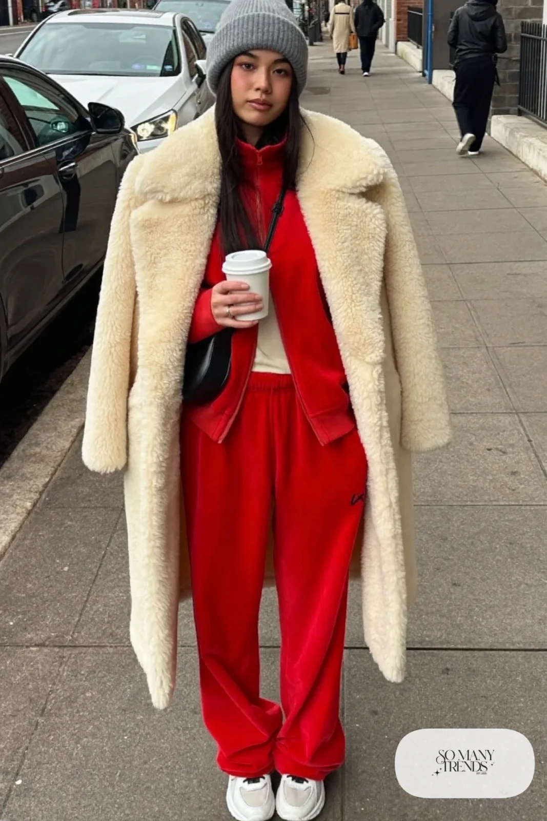 cherry red velour tracksuit long shearling coat white sneakers beanie crossbody bag outfit 4