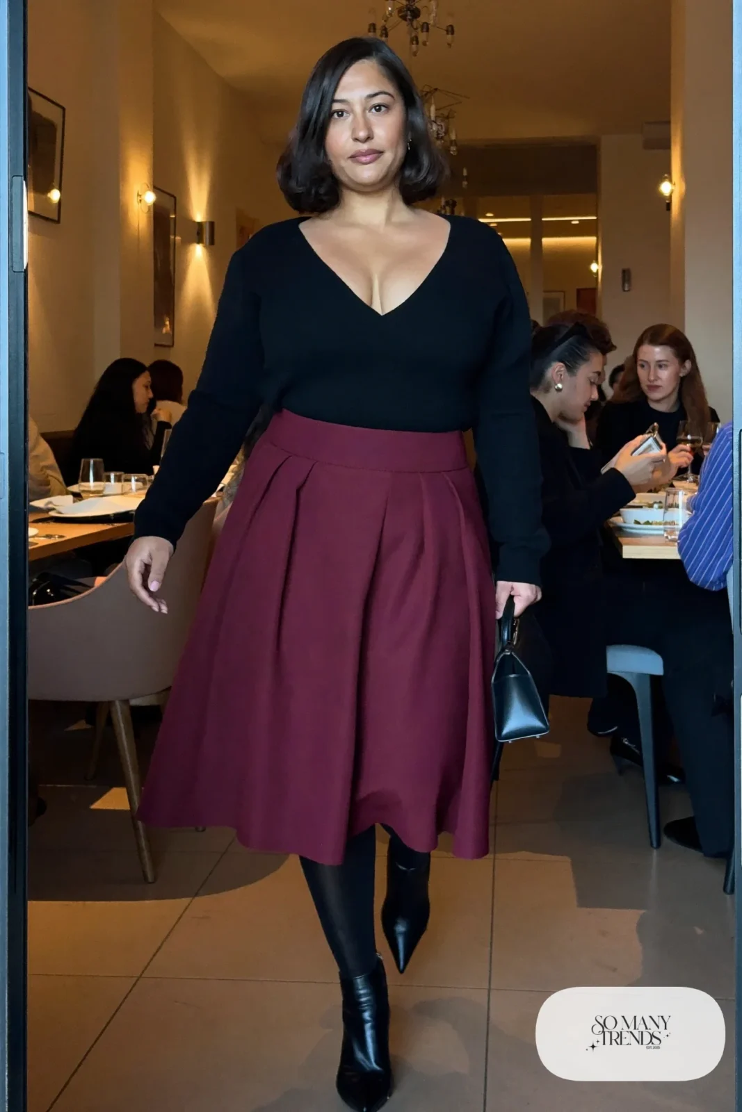 burgundy crepe A-line midi skirt, black V-neck knit tucked in, sheer black tights, pointed boots outfit 15