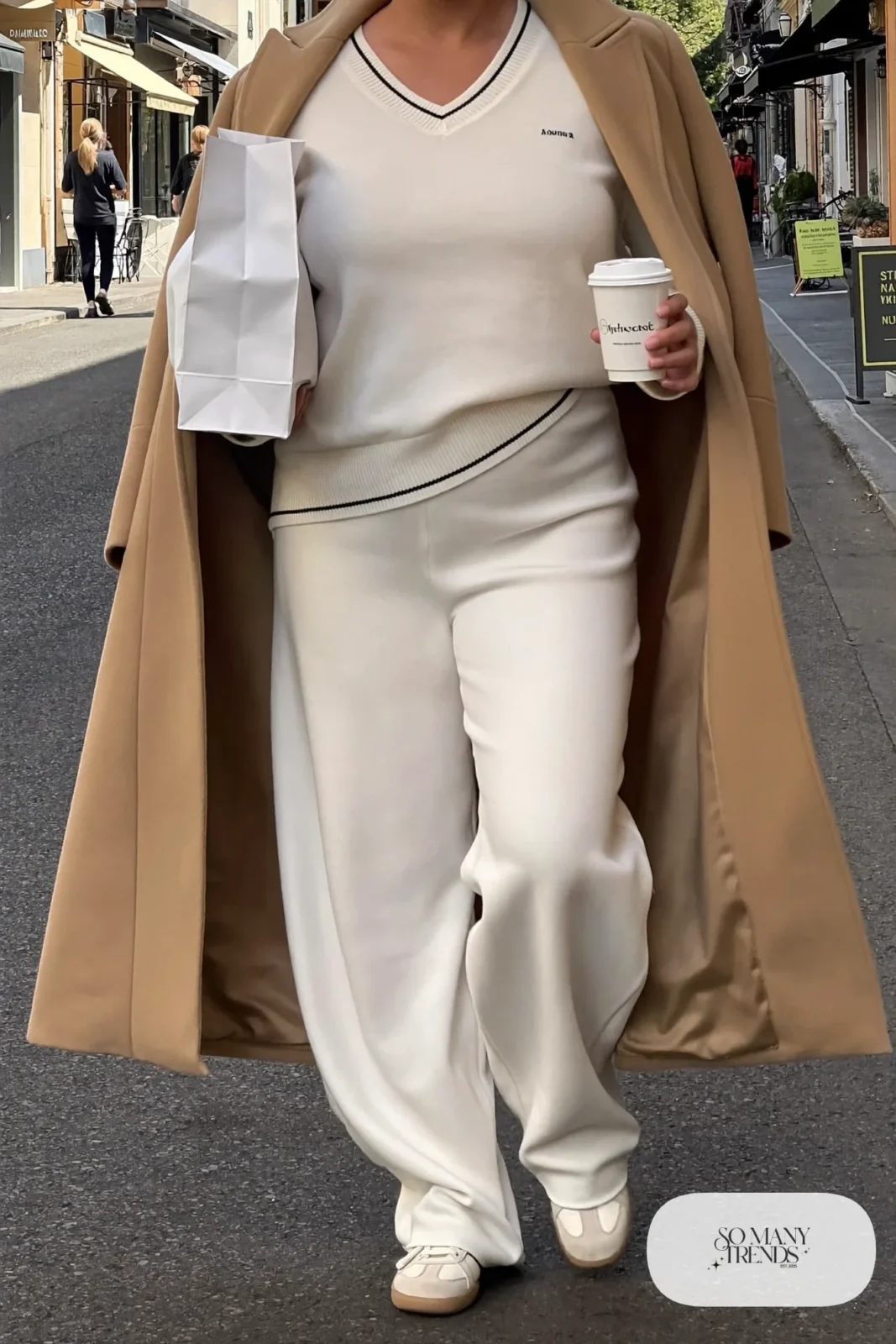 cream V-neck knit sweater, matching wide-leg knit pants, camel coat, cream sneakers outfit 21