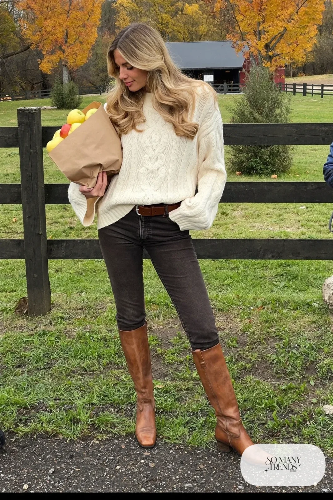 chunky cream cable knit sweater dark slim jeans tucked into brown leather riding boots outfit 7