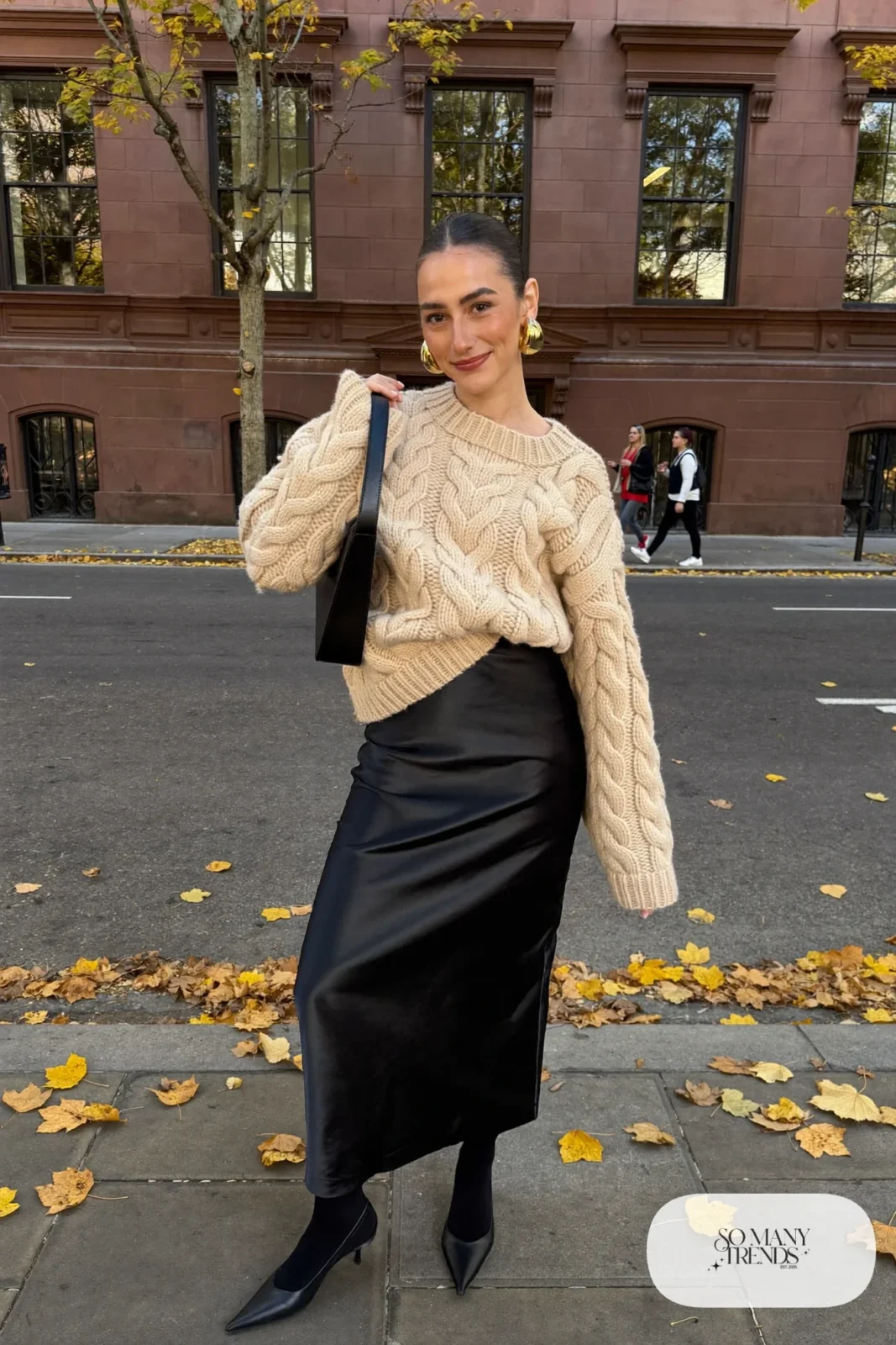 black satin midi skirt oatmeal chunky cable knit sweater sheer black tights tall black boots outfit 2