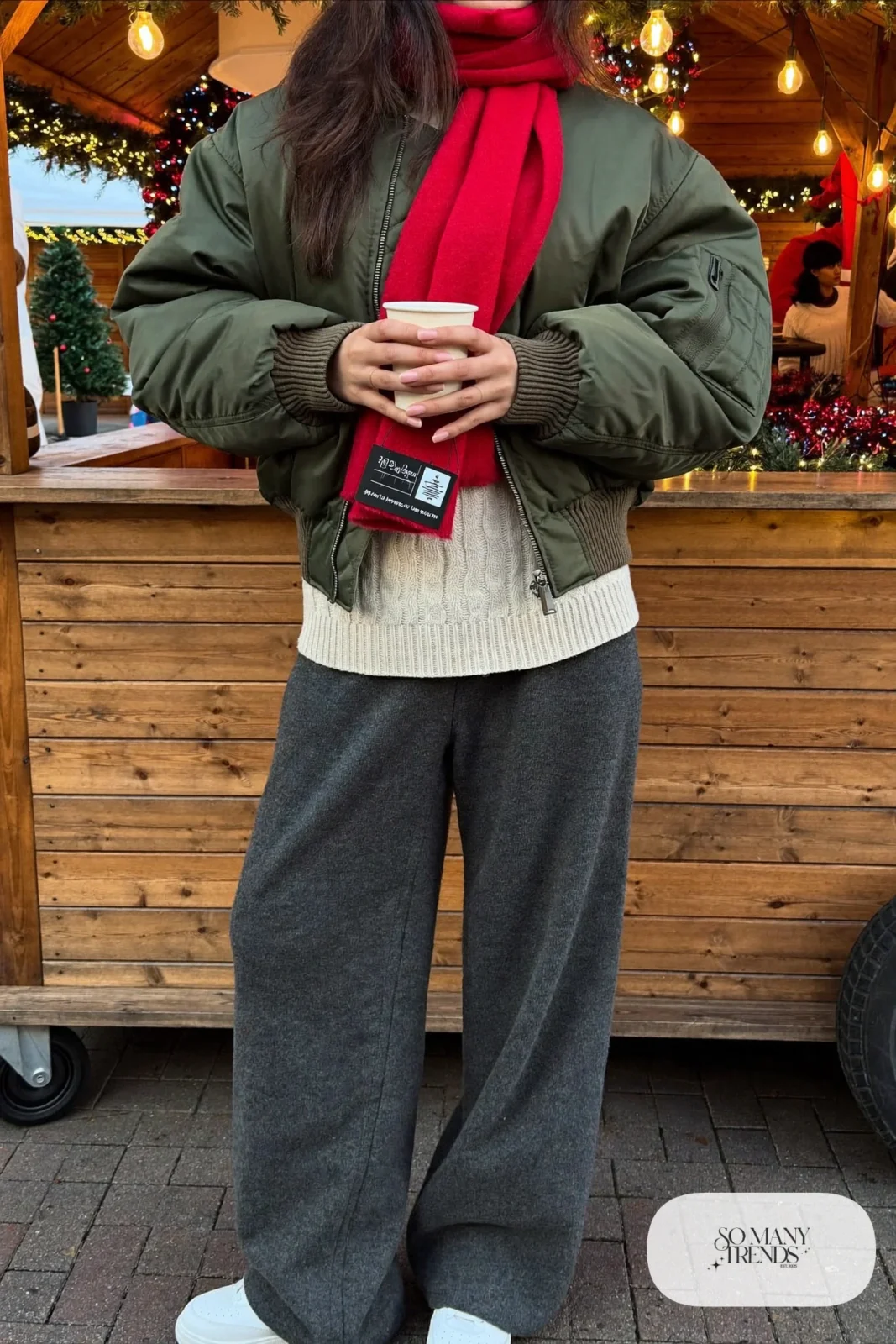 olive bomber jacket charcoal knit wide joggers white sneakers red scarf cream sweater christmas market outfit 17