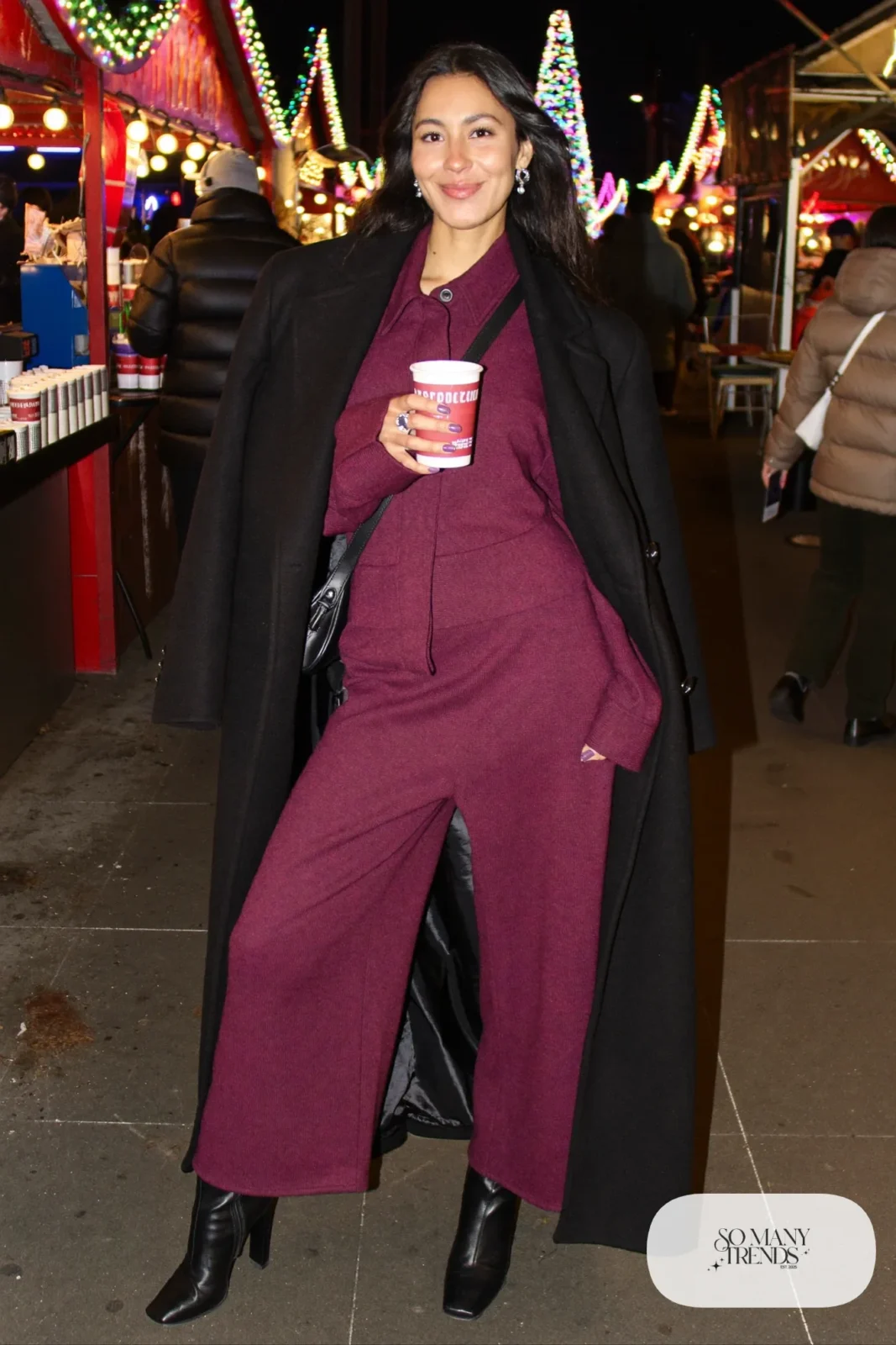 plum knit wide-leg jumpsuit long black wool coat heeled boots crossbody bag christmas market outfit 30