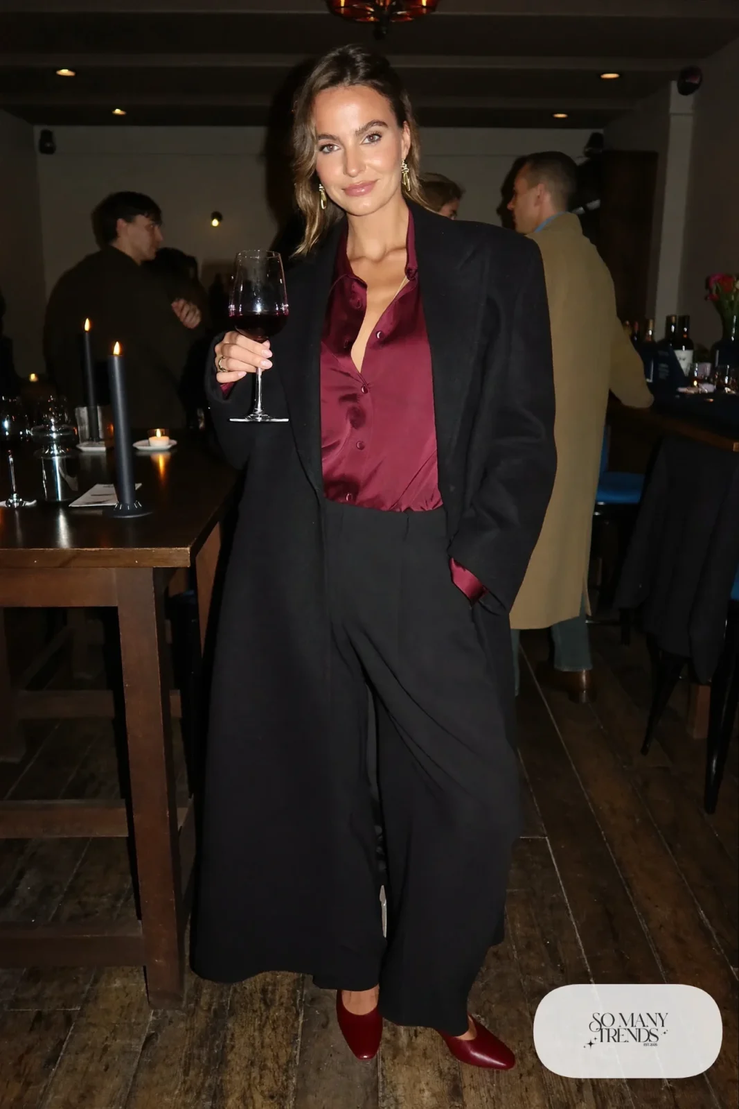 wine satin blouse black wide-leg pants red closed-toe pumps long black wool coat outfit 4