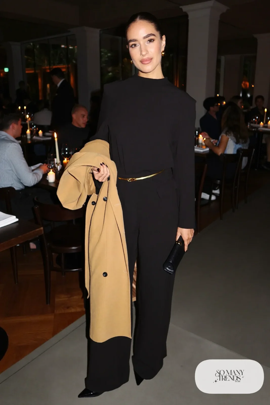 black wide-leg jumpsuit gold belt pointed black heels long belted camel coat outfit 12