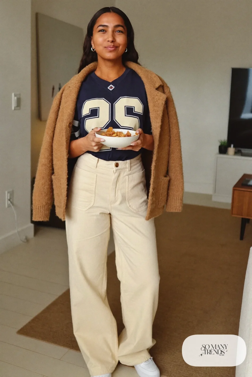navy jersey tee cream wide-leg pants camel cardigan over shoulders white sneakers outfit 3