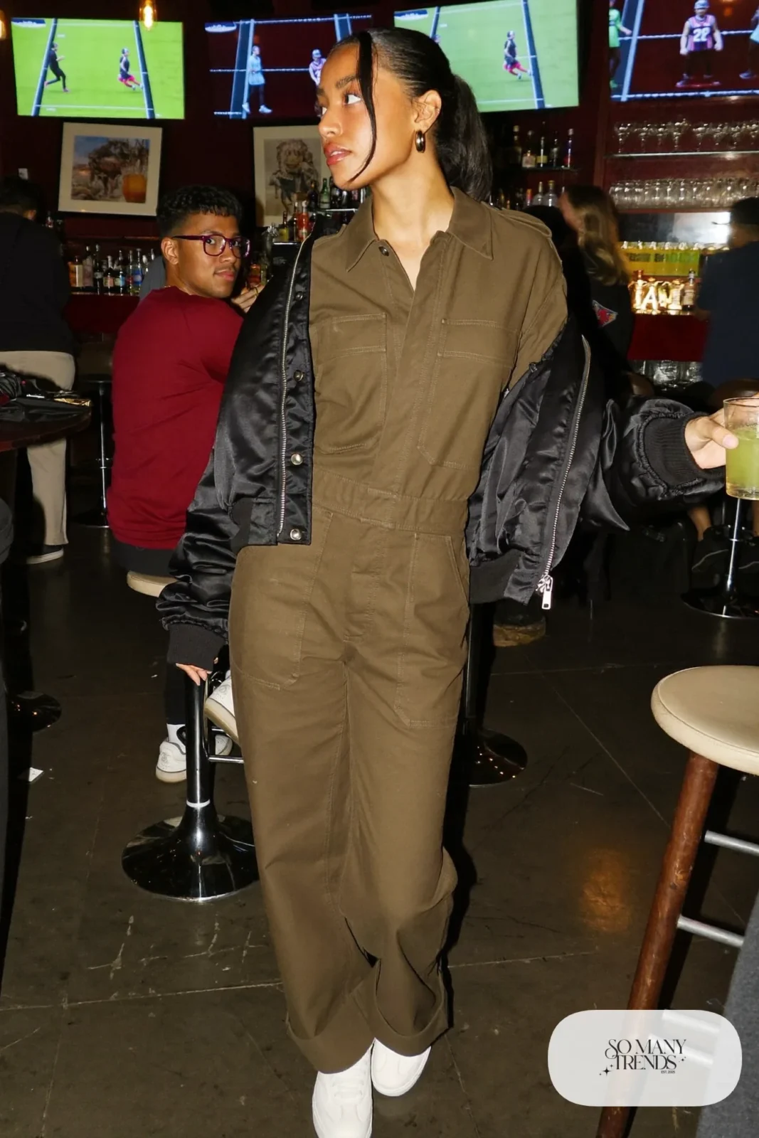 olive twill utility jumpsuit black satin bomber jacket white sneakers gold hoops outfit 17