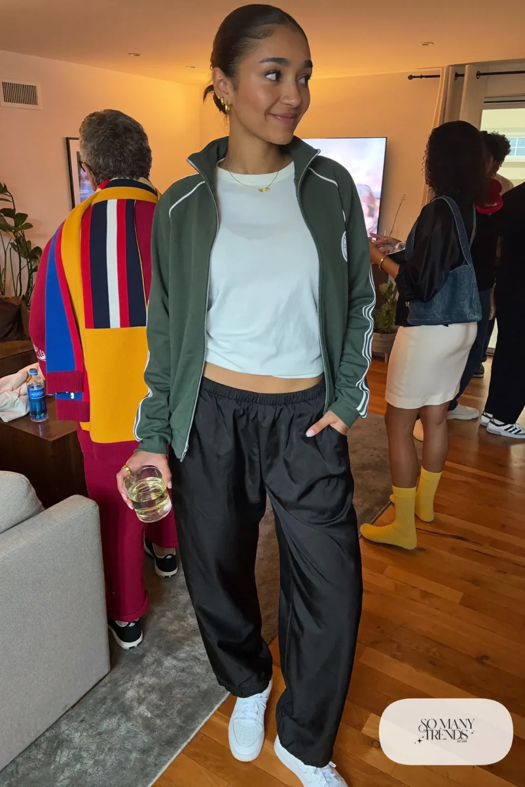 green retro track jacket black satin wide-leg pants white tee white sneakers outfit 26