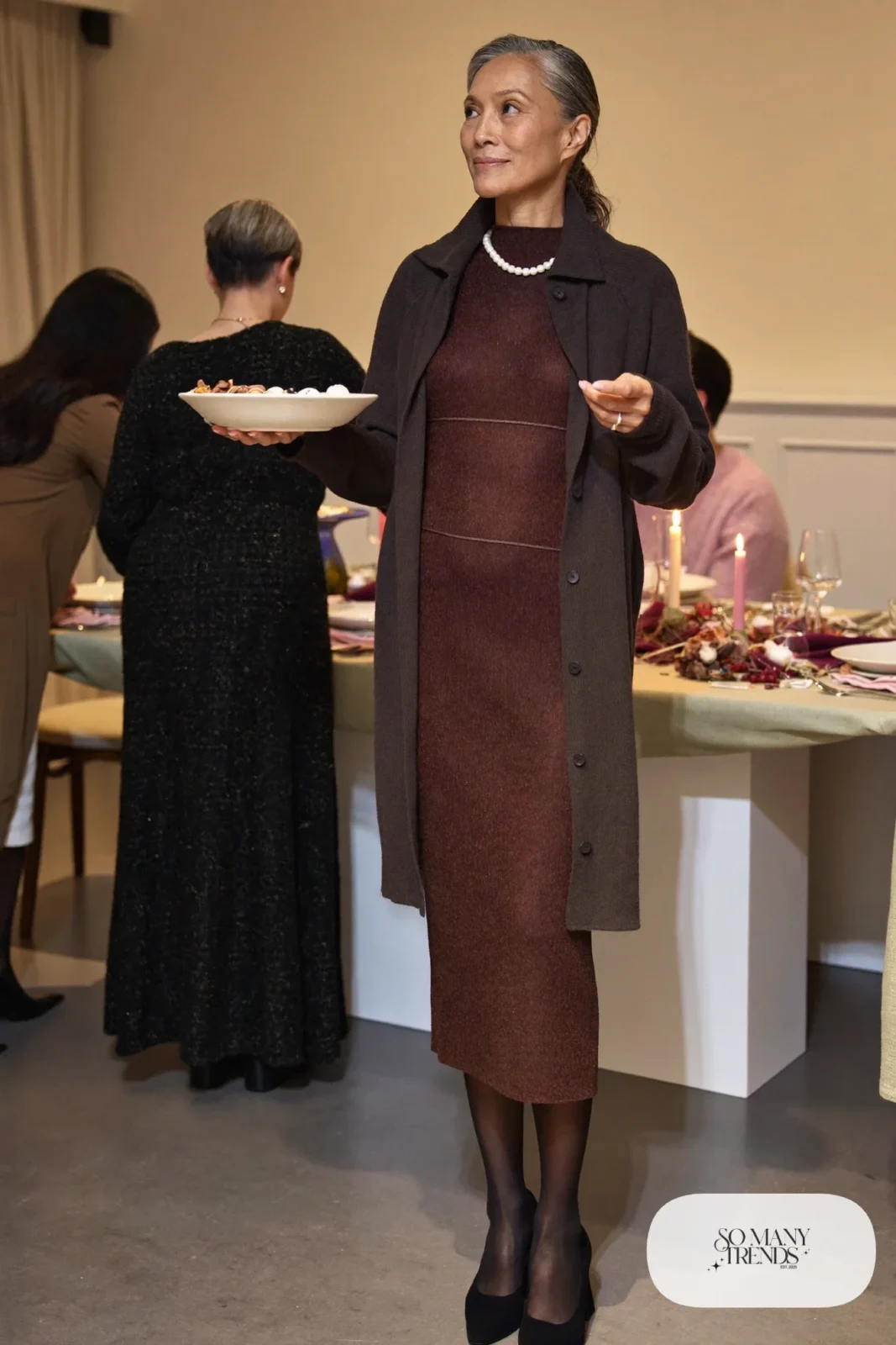 Woman in her fifties in a burgundy knit midi dress, sheer black tights and closed-toe block-heel pumps, outfit 22