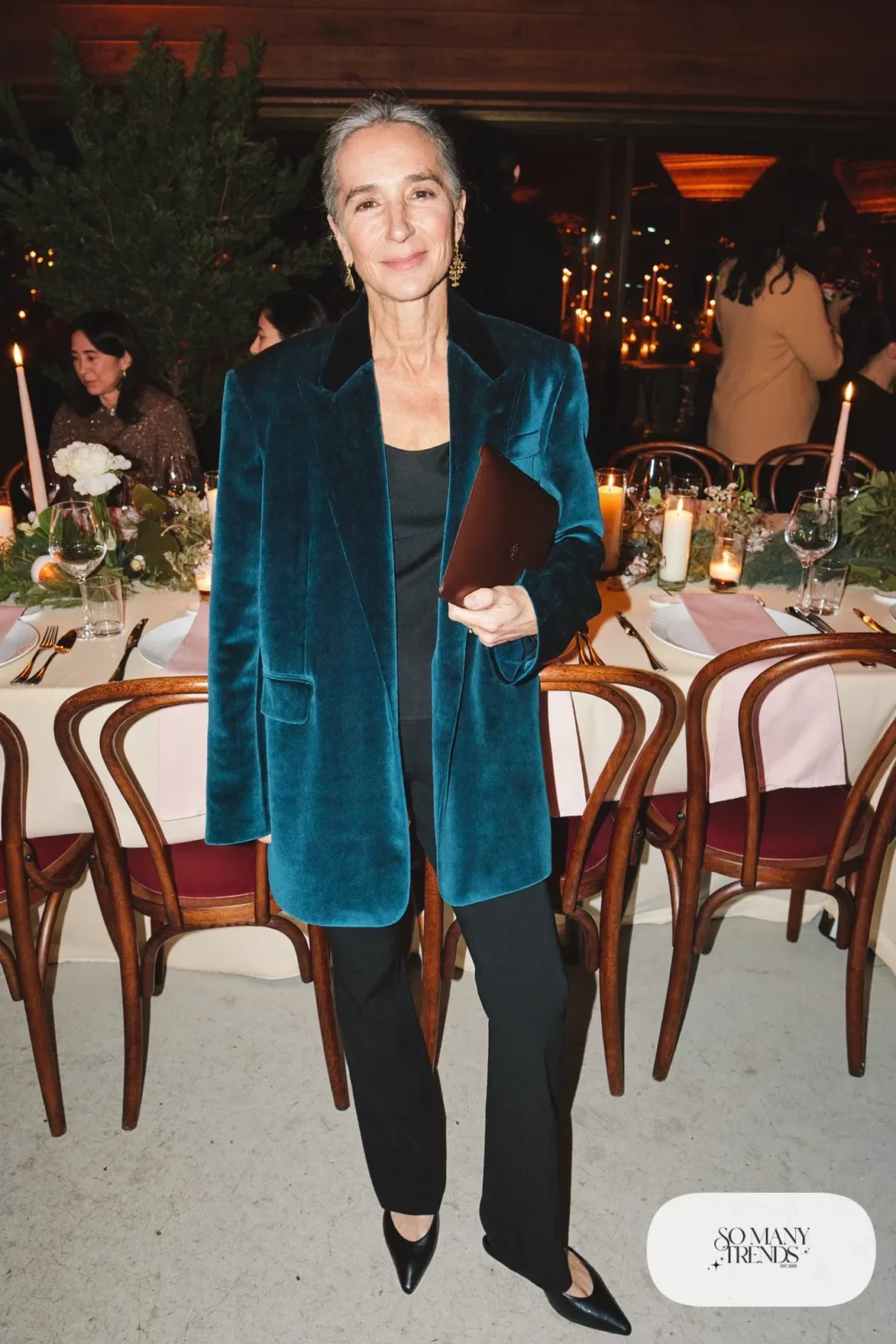 Woman in her fifties in a deep teal velvet blazer, black top, slim black pants and closed pointed pumps, outfit 24