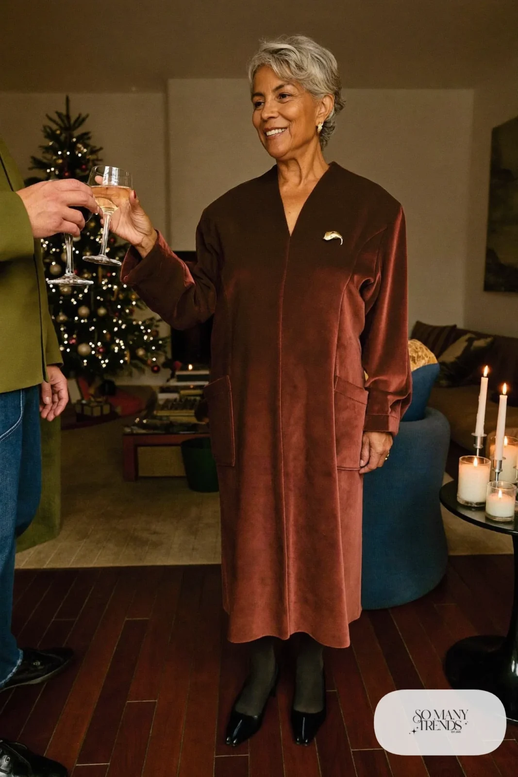 Petite woman in a burgundy velvet V-neck midi dress with black tights and low heels at a holiday dinner, outfit 25