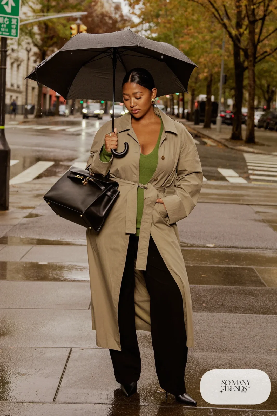 Woman in a belted stone trench coat over a knit top and wide-leg pants with boots, outfit 15