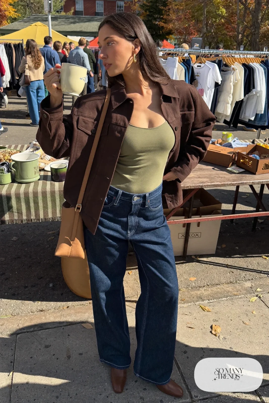Woman in an espresso shirt jacket over a fitted tee with dark wide-leg jeans and boots, outfit 26