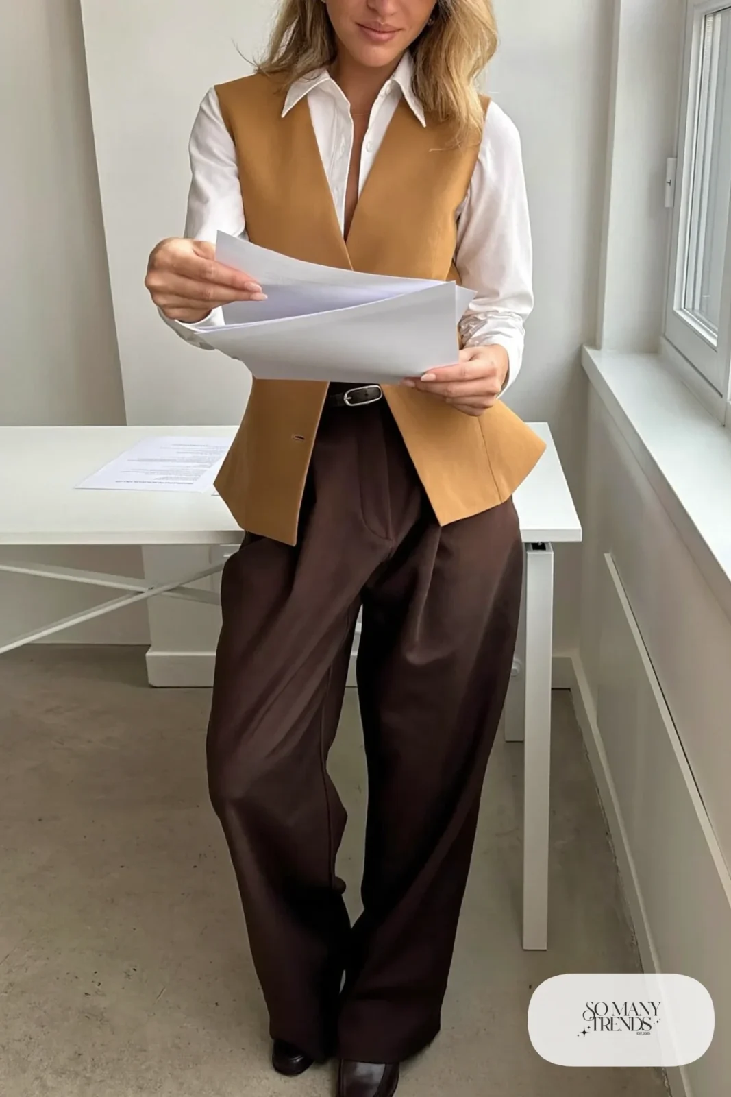 Woman with a straight athletic figure in a white shirt, a camel tailored vest, brown wide-leg pants and a belt with loafers, outfit 15