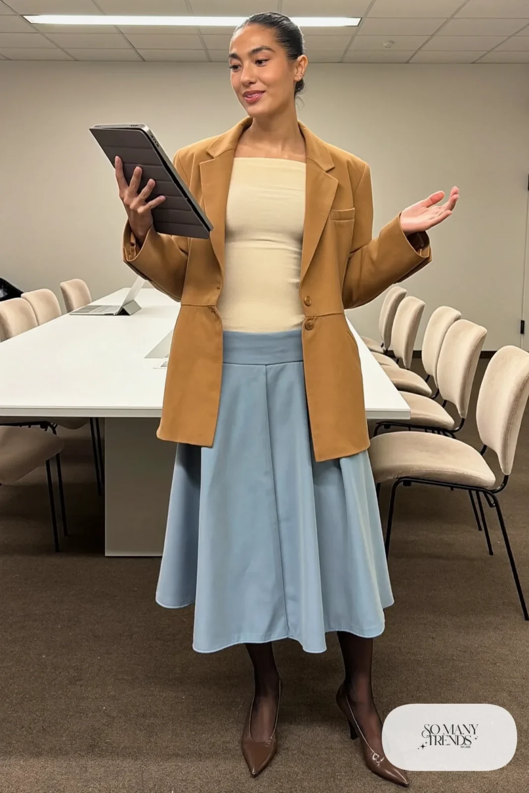 Woman with a straight athletic figure in a camel nipped-waist blazer, a baby blue flared midi skirt and pumps, outfit 25