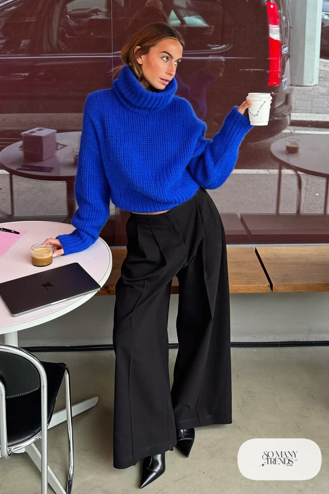 Woman with pear-shaped figure in a cobalt cowl-neck sweater, black wide-leg pants and black ankle boots, outfit 4