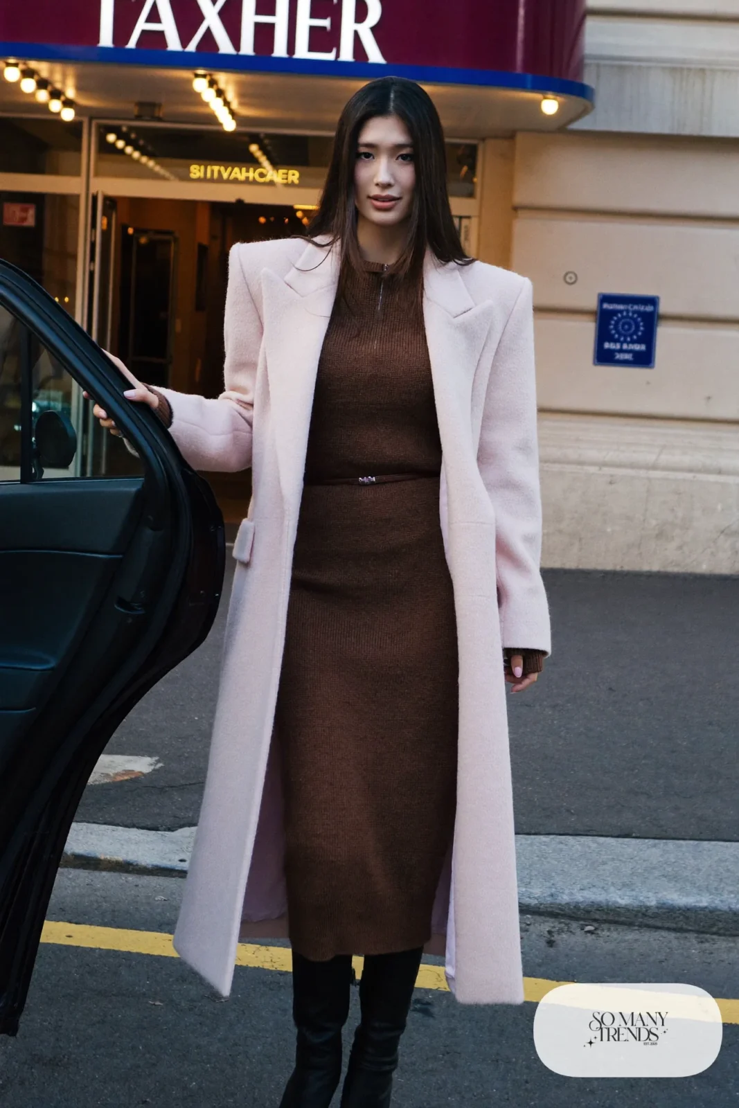 Woman with pear-shaped figure in a long pale pink wool coat, espresso knit dress and black boots, outfit 14