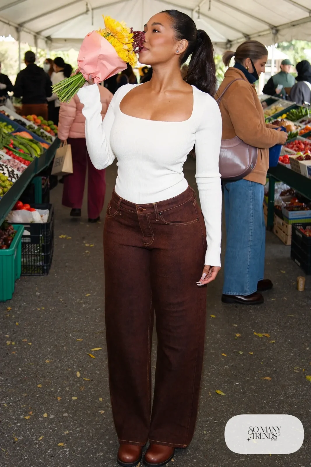 Woman with pear-shaped figure in a white square-neck top, dark wide-leg jeans and brown clog boots, outfit 15